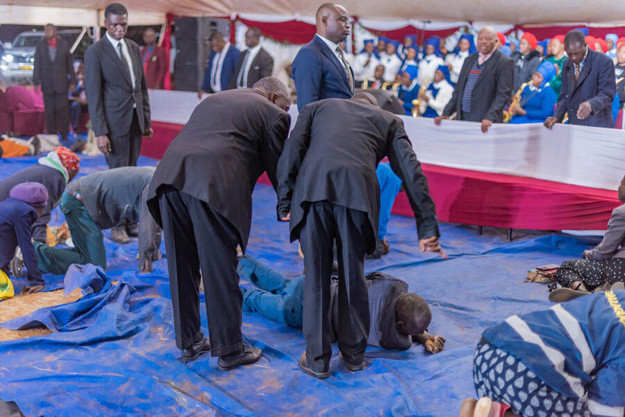 Ministers praying over congregation