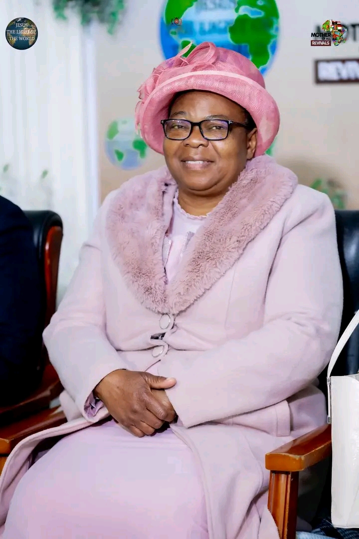 Mother Of All Revivals — church leader seated in pink