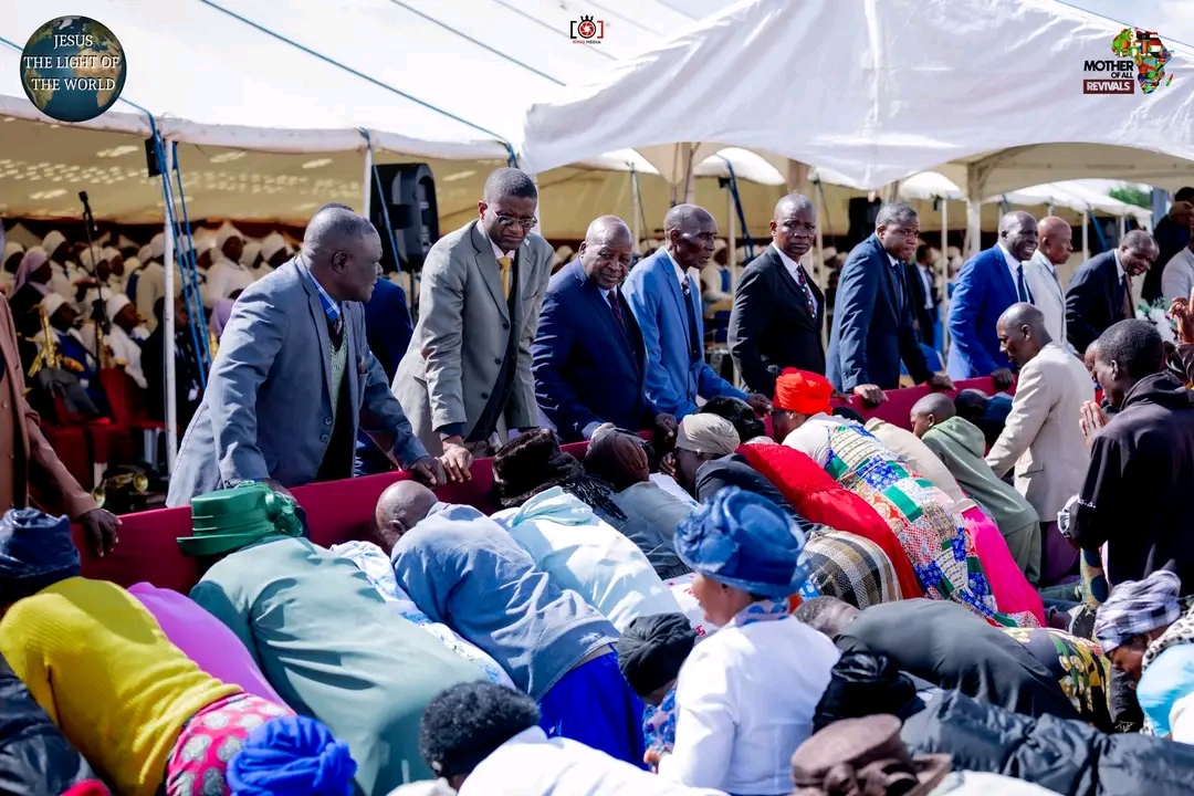 Mother Of All Revivals — ministers praying over congregation